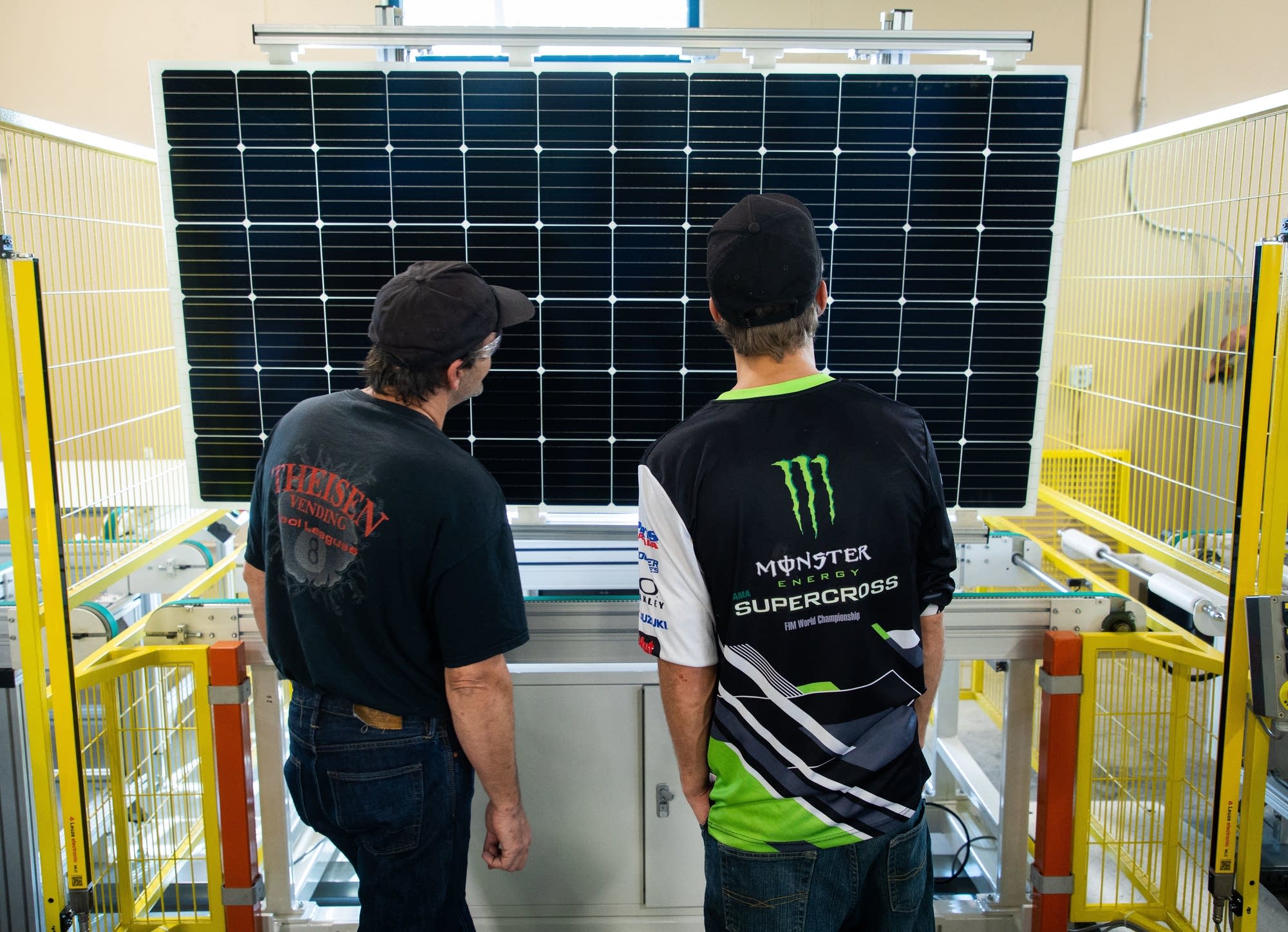 Jared Brincefield and Allen Mart inspect a nearly completed solar panel