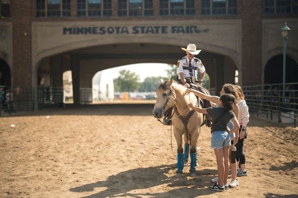 Kids pet a horse