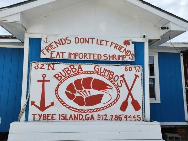 A sign at Bubba Gumbos reads "Friends don't let friends eat imported shrimp."
