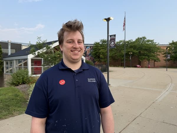 A man stands outside of a polling place.