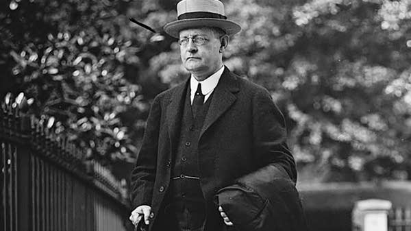 A black and white photo of a man in a suit.