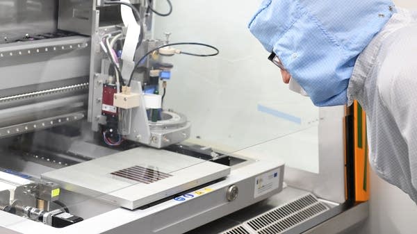 A technician watches a solar panel being printed in a Saule company laboratory in Wroclaw, Poland, in January.