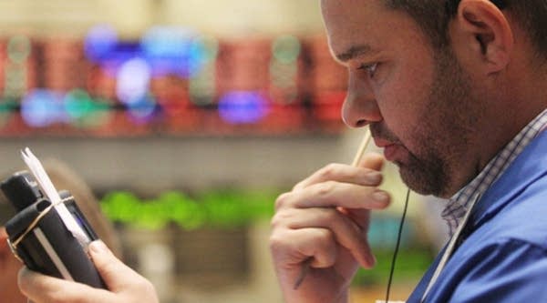 A trader works on the floor of the New York Stock Exchange after the opening bell on August 5, 2011 in New York City.