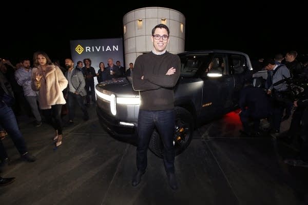 Amazon says it will order 100,000 electric delivery vans from Rivian. Above, Rivian CEO RJ Scaringe shows off the company's electric pickup truck at the Griffith Observatory in Los Angeles in 2018. 
