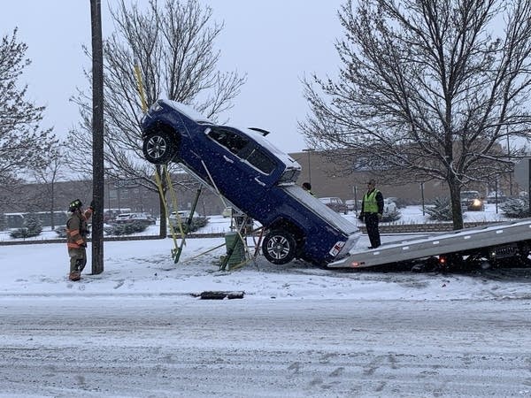 Pickup truck does balancing act on slippery road