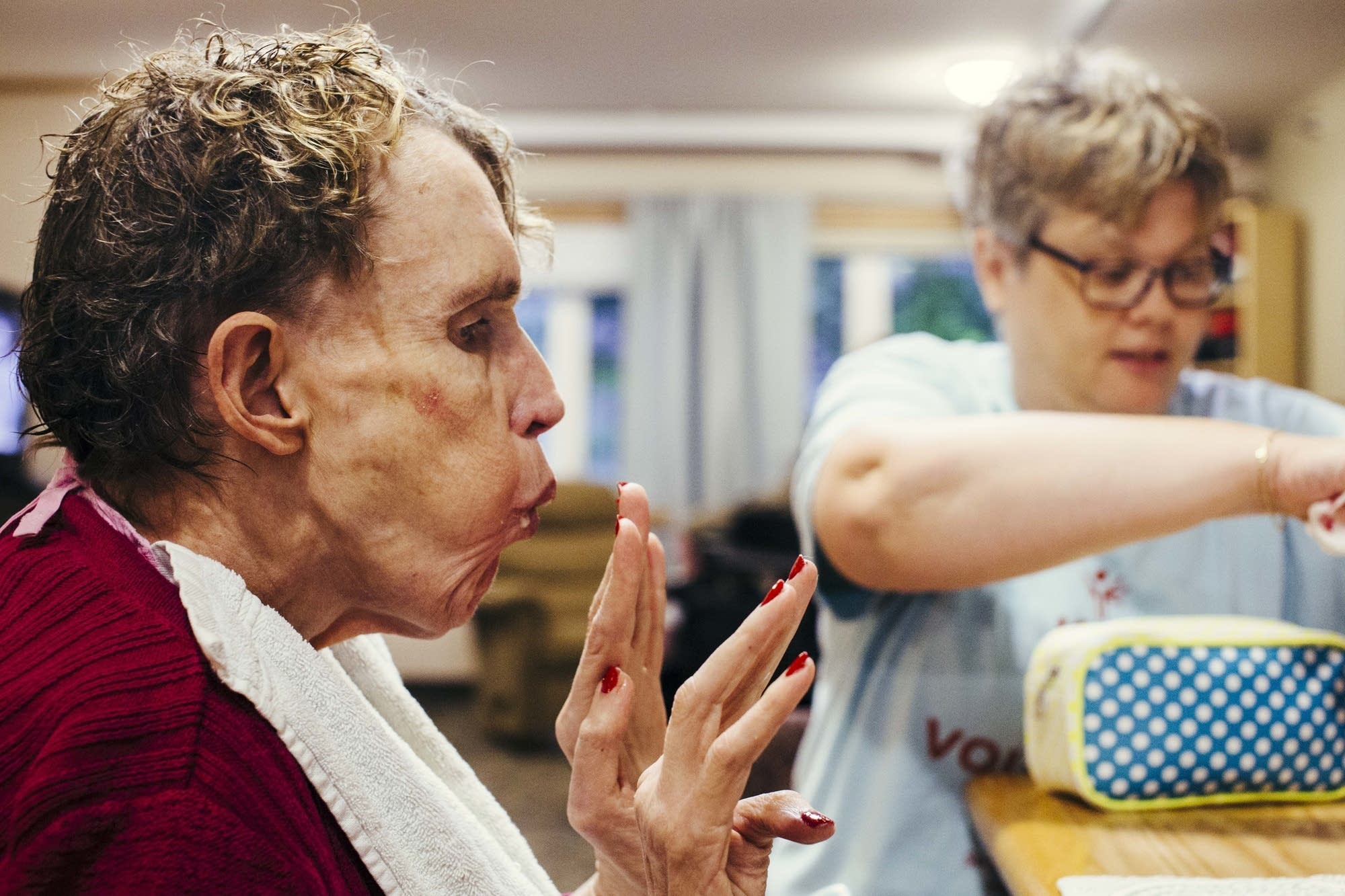 Jill Evensen blows on her freshly painted nails.