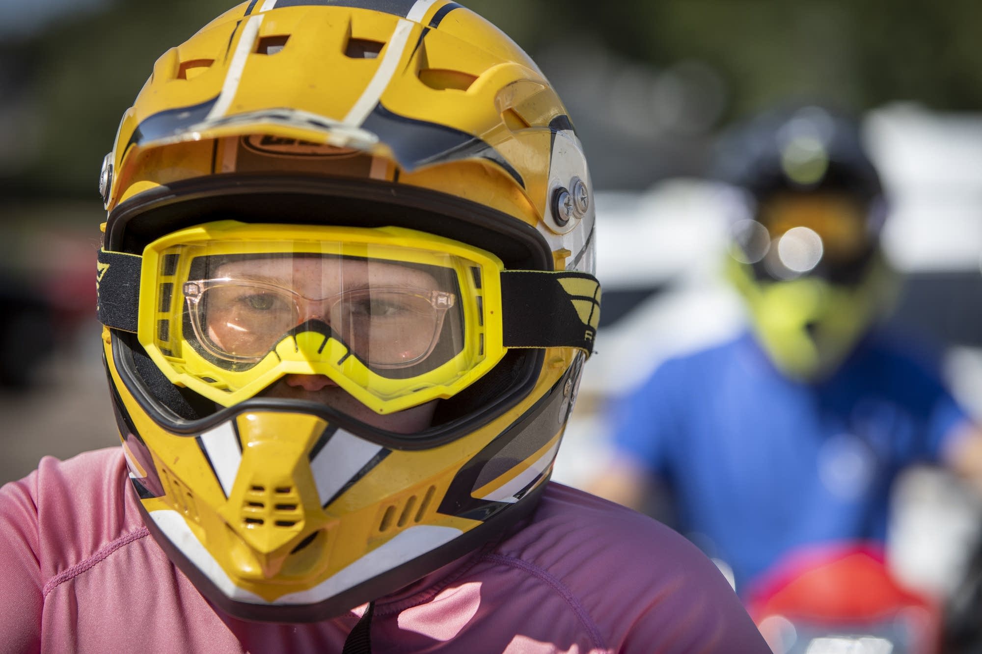 A young girl wearing a yellow helmet