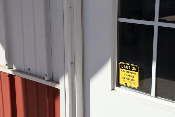 A yellow "CAUTION" sign on door.