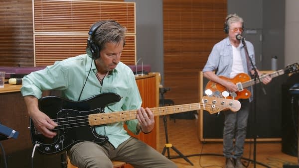 Two musicians performing in a recording studio
