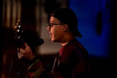 Band member singing into microphone