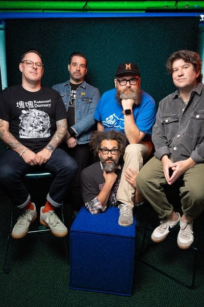 Five members of Motion City Soundtrack pose for a photo.
