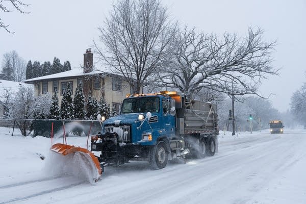 A snow plow clears the road