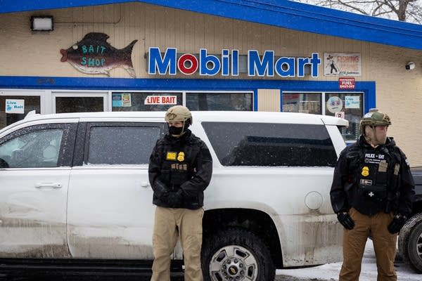 Border patrol agents at a gas station