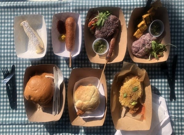 Seven fair foods lined up on a table