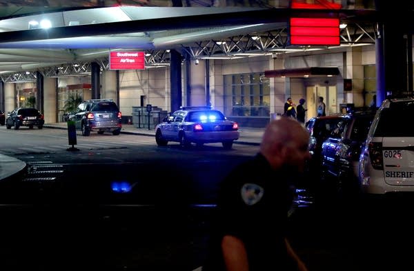 An officer directs traffic at New Orleans airport