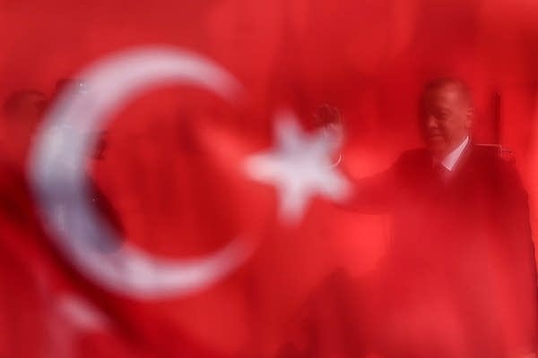 Turkish President and the leader of Turkey's ruling Justice and Development (AK) Party Recep Tayyip Erdogan is seen behind a Turkish Flag (Photo by Onur Coban/Anadolu Agency/Getty Images)