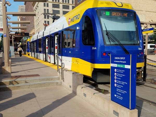 A rider boards a Green Line light rail train.