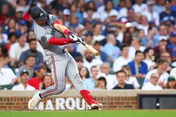 Twins player swinging at baseball