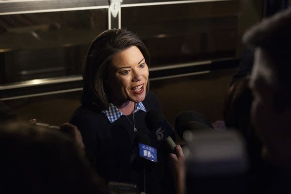 Angie Craig speaks to the news media as she enters her election party.