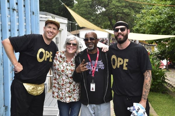 Four people pose for a photo together at a fair