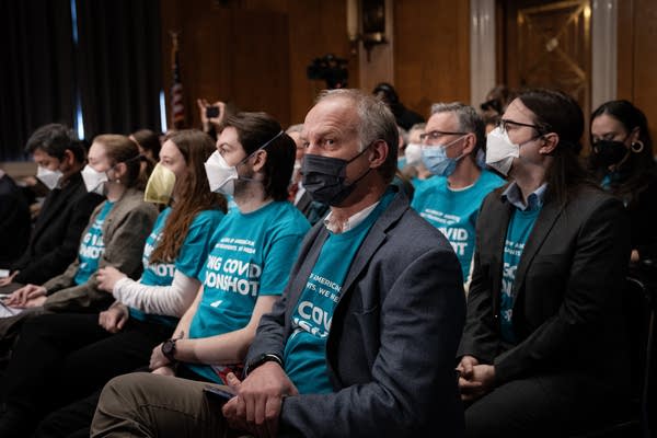 People sit with masks on