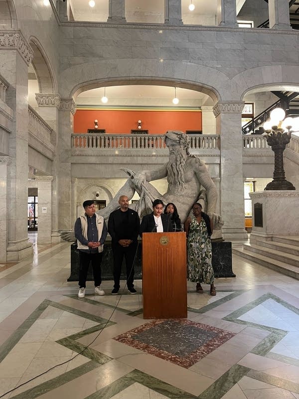 People stand at podium