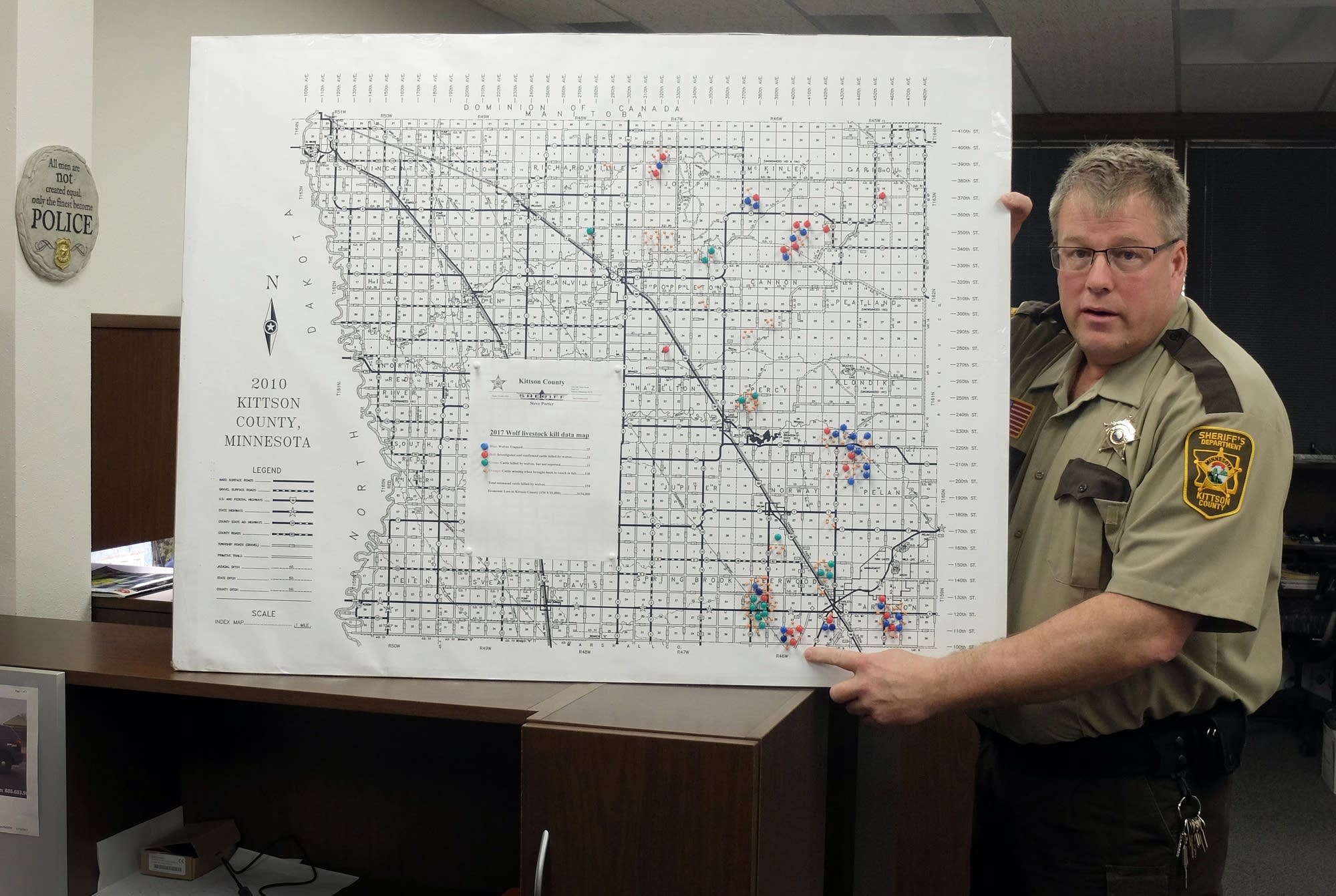 Sheriff Porter explains a map created to note cattle killed by wolves.