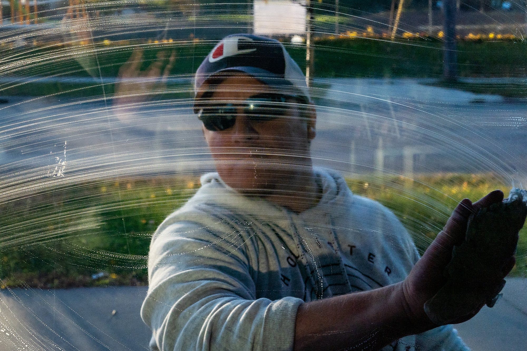 Johnny Petty cleans the door of a charity where he volunteers.