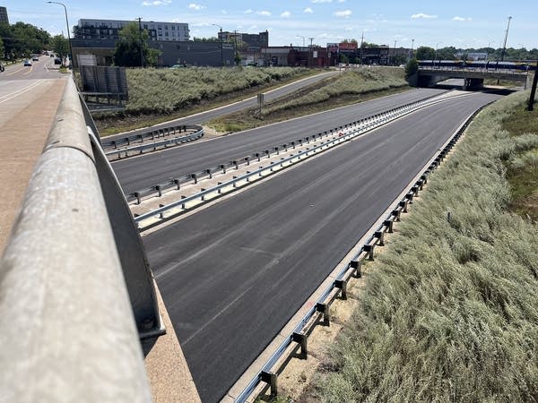 A view of a freshly paved highway without traffic lines.