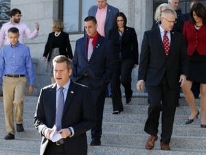 Kurt Daudt leads House member to press conference.