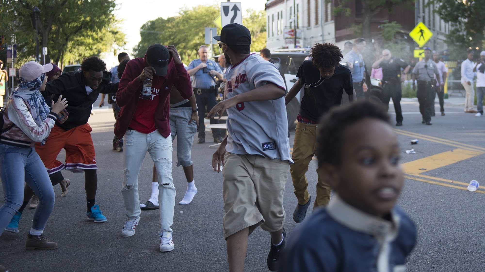 Members of the crowd and protestors flee the area.