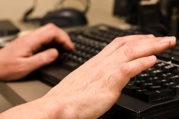 A person types on a keyboard