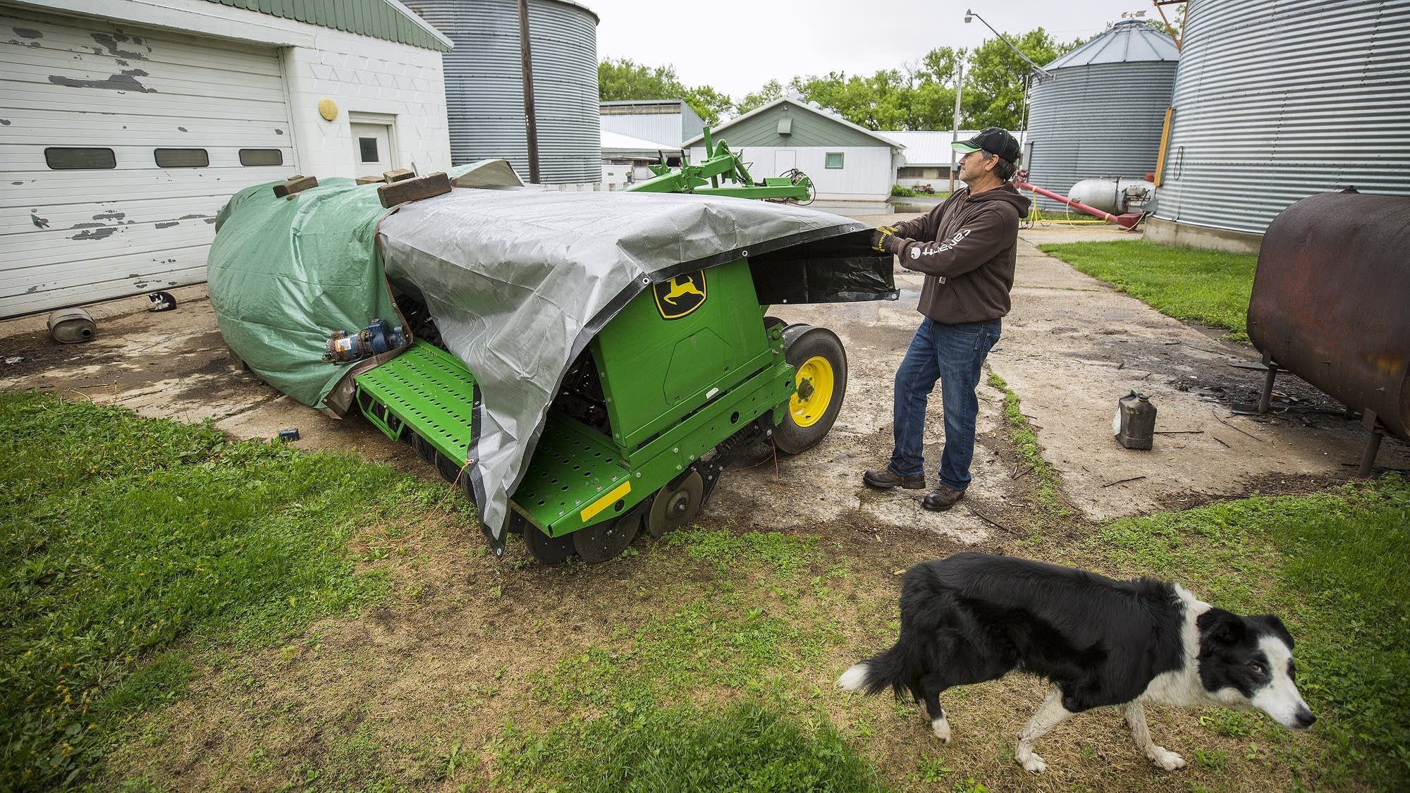 Dave Lochen covers up a machine that he will use to plant cover crops.