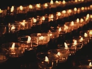 Candles burning in the dark.