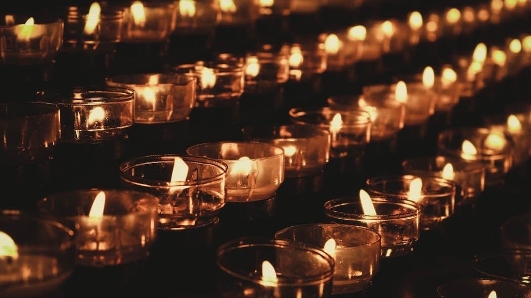 Candles burning in the dark.