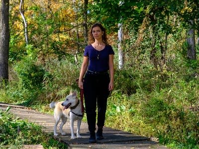 Liz Draper standing on path with dog.