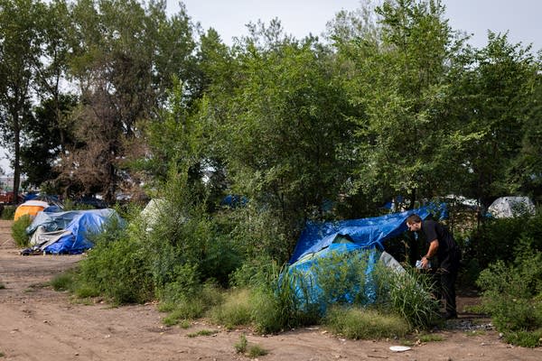 A person leaves a pack of water outside a tent