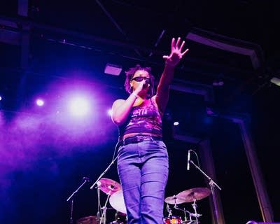 A musician sings and gestures during on onstage performance