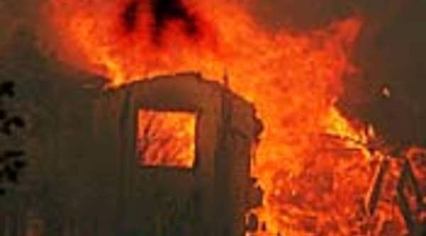 A house burns in Poway, Calif., during the Witch Fire on Oct. 23.
