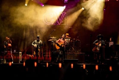 A band performing on an outdoor stage
