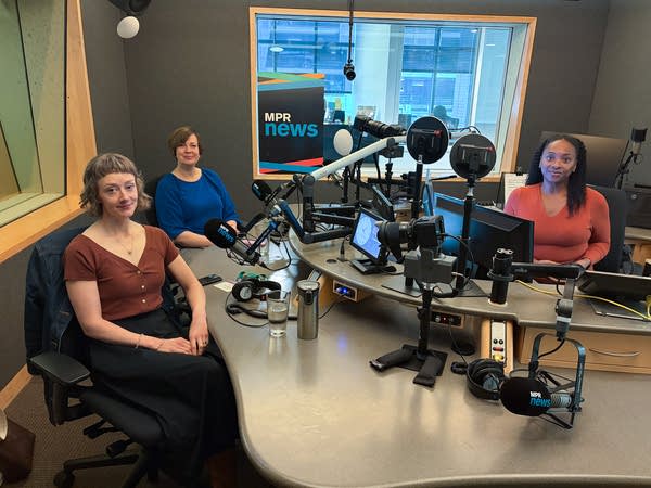 three women smiling in a broadcast studio