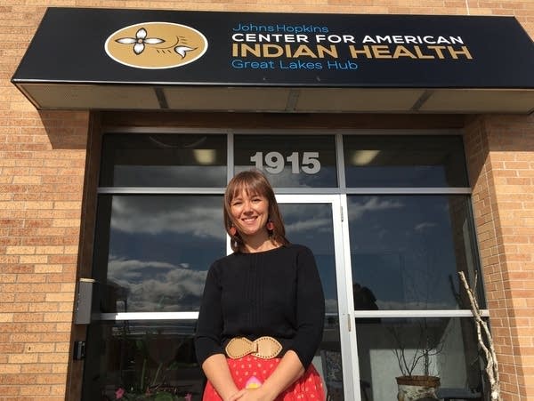 A woman stands in front of an office in Duluth. 