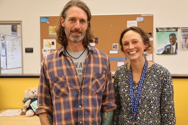 a man and a woman pose for a photo