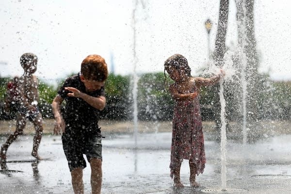 Children cool down as they play in a public fountain during summer heat on July 19, 2019 in New York City.