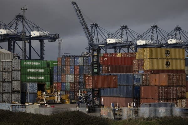 Crates are stacked at Felixstowe Port on November 16, 2020 in Felixstowe, England. Shipping companies and retailers have complained of delays in unloading arriving freight, with one ship told it could wait up to 10 days for a berthing slot.