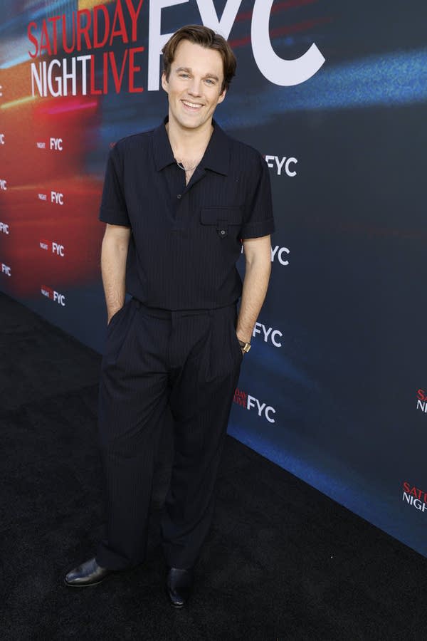 A man poses for a portrait outside a media event