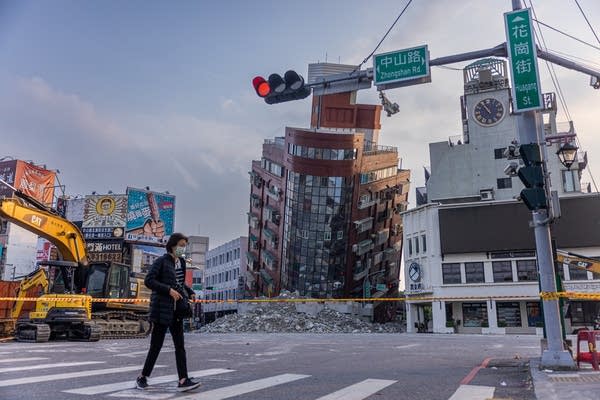 HUALIEN, TAIWAN - APRIL 04: A person walks past an area of a damaged building is cordoned off following the earthquake on April 04, 2024 in Hualien, Taiwan. A 7.5 magnitude earthquake hit eastern Taiwan on Wednesday, triggering a tsunami warning for the coastline in Taiwan, the Philippines and Japan.