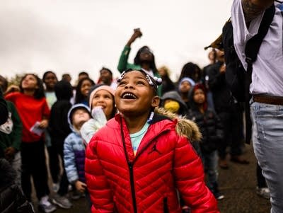 Students watch as a balloon honoring the 49th birthday of George Floyd 