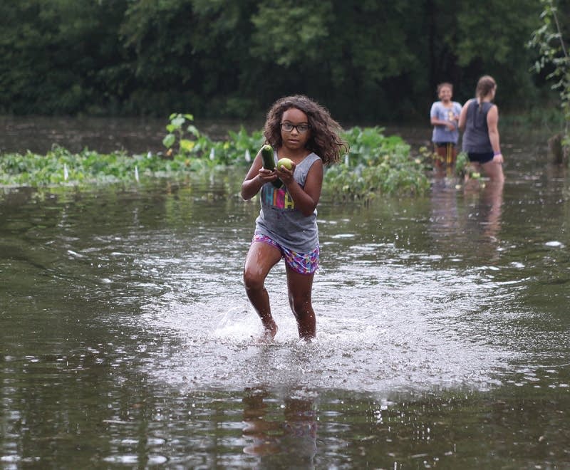 Brooklynn Harmon of Saukville, Wis., carries food.