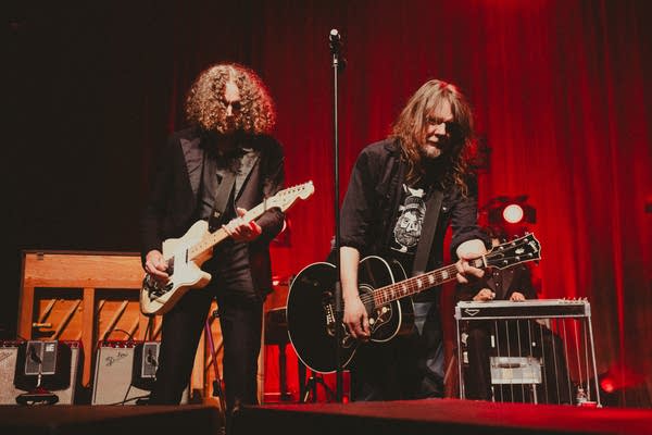 Two guitarist performing together onstage